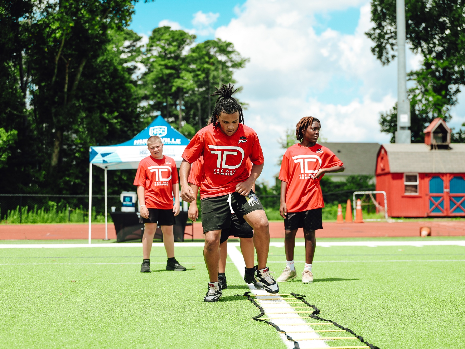 Youth athletes running ladder drills at the Tré Day Combine