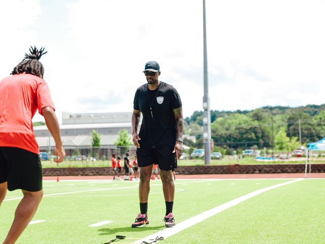 Coach Tre' on the field with athletes